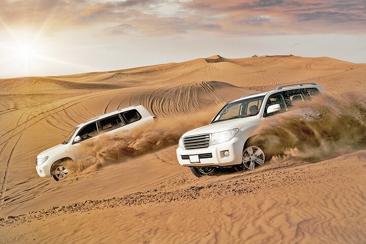 Experience the serene beauty of the Lehbab Desert as powerful 4x4 vehicles glide over endless golden sands making for an unforgettable morning adventure amid stunning dune landscapes.